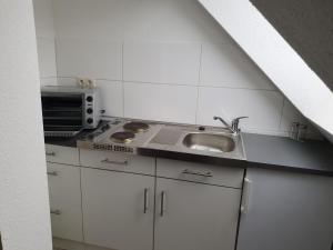 a kitchen with a sink and a microwave at Fewo-Am-Tanger in Tangerhütte