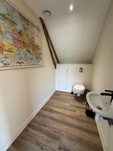 a bathroom with a sink and a toilet at Appartement spacieux au domaine in Coust +8 photos
