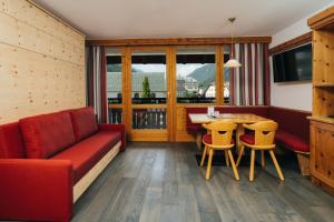 a living room with a couch and a table and chairs at Ferienresidenz Raich - Appartements mit Sky Wellness und Garten in Ried im Oberinntal