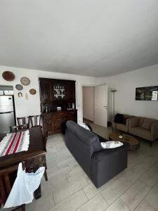 a living room with a couch and a table at Casa Balzarini- Vecchio Mulino in Entracque