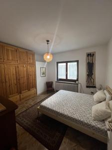 a bedroom with a bed and a window at Casa Balzarini- Vecchio Mulino in Entracque