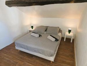 a bedroom with a bed with two night stands at Le Petit Attique de Versailles in Versailles