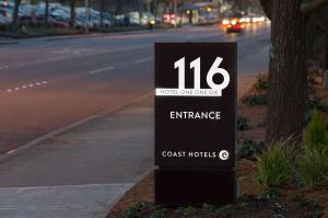 a sign sitting on the side of a street at Hotel 116, A Coast Hotel Bellevue in Bellevue