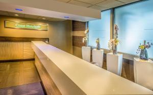 a lobby of a fast food restaurant with a long counter at Hotel 116, A Coast Hotel Bellevue in Bellevue