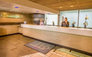 a man and a woman standing at a counter in a restaurant at Hotel 116, A Coast Hotel Bellevue in Bellevue