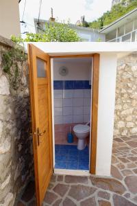 a bathroom with a toilet inside of a house at House Dragica in Grižane +25 photos