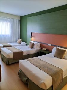 a hotel room with three beds in a room at Hotel Naval Sestao in Sestao +38 photos
