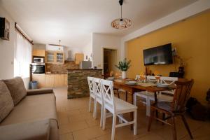 a kitchen and dining room with a table and chairs at House Dragica in Grižane