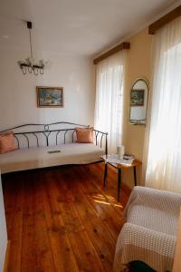 a bedroom with a large bed and a wooden floor at House Dragica in Grižane