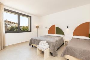 a bedroom with two beds and a window at Via Tirso Rooms & Studio in Tortolì