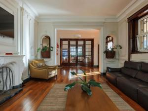 a living room with a couch and a fireplace at ibis Belo Horizonte Liberdade in Belo Horizonte