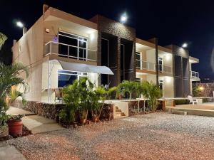 a large building with plants in front of it at night at Yaque Land in El Yaque