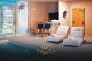 a living room with two chairs and a pool at Wellness chalet Smokovec in Vysoké Tatry