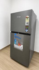 a refrigerator sitting on top of a floor at Dimond Villa in Greater Noida