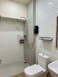 a bathroom with a shower with a toilet and a sink at Full House Chiangkhan 21 in Chiang Khan