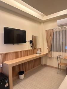 a living room with a flat screen tv on a wall at Full House Chiangkhan 21 in Chiang Khan +40 photos