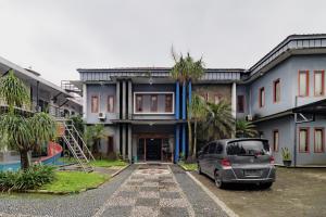 a car parked in front of a house at Urbanview My Grand Hotel Bogor in Brujul