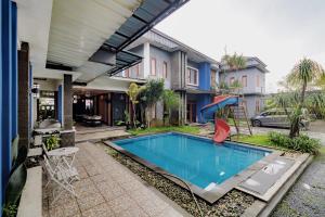 a swimming pool in the backyard of a house at Urbanview My Grand Hotel Bogor in Brujul