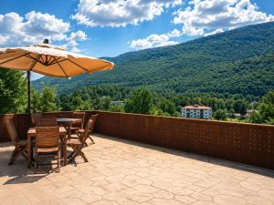a patio with a table and an umbrella at Tenuta VERBICARO in Morano Calabro