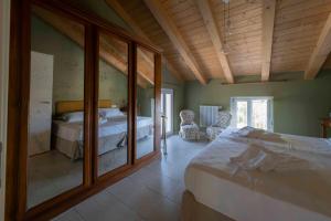 a bedroom with a large bed and a mirror at Ca' Lodola in Borzano