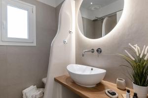 a bathroom with a white sink and a mirror at Naxian Pearl in Mikri Vigla +85 photos