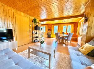 a living room with a couch and a table at Chalet Siesta OG in Bellwald