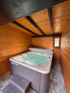a jacuzzi tub in a room with wooden walls at Chata Andromeda in Oravská Lesná +75 photos