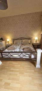 a bedroom with a bed with two lamps on two tables at Cityzimmer in Nettetal +12 photos