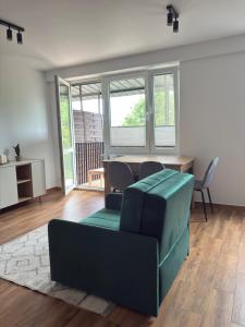 a living room with a couch and a table at Apartament Kopernikus in Grodzisk Mazowiecki +23 photos