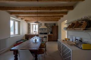 a kitchen with a wooden table in a room at Ca' Lodola in Borzano