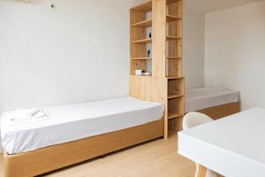 a small room with a bed and a book shelf at Антична панорама in Hisarya