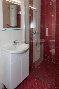 a bathroom with a white sink and a shower at Антична панорама in Hisarya +12 photos