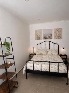 a bedroom with a bed and two lamps and a ladder at The Nook II, Lourinha in Lourinhã