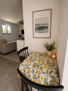 a living room with a table and a chair at The Nook II, Lourinha in Lourinhã