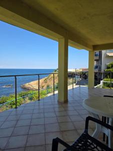 a balcony with a view of the ocean at The Yellow House in Ahtopol
