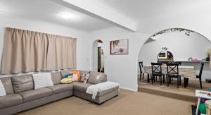 a living room with a couch and a table at 4BR big family house with huge pool in Brisbane
