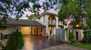 a large house with a driveway in front of it at 4BR big family house with huge pool in Brisbane