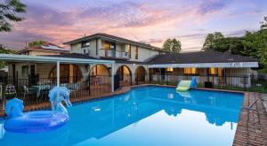 a swimming pool in front of a house at 4BR big family house with huge pool in Brisbane