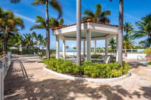 a gazebo at the beach with palm trees at Designer Oceanview Penthouse & Pool - Condado in San Juan