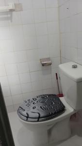 a bathroom with a toilet with a lid on it at Js Immobilier in Abidjan