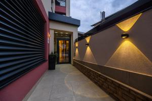 a hallway of a building with lights on the wall at Pansion Garni in Bihać +131 photos