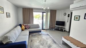 a living room with a couch and a television at Villa Zümrüt in Ortaca