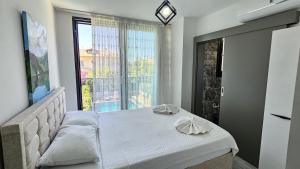 a bedroom with a bed and a large window at Villa Zümrüt in Ortaca +38 photos