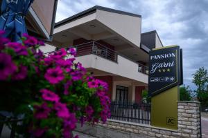 a building with a sign that reads passion gem estates at Pansion Garni in Bihać
