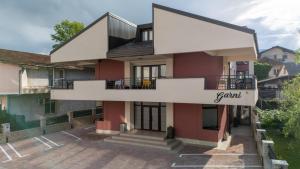 a house with a balcony with the word youth on it at Pansion Garni in Bihać