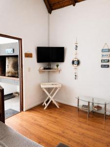 a living room with a flat screen tv on a wall at Dwarskersbos,Skilliepark in Velddrif