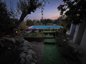 a swimming pool with a green lawn and a house at White House R&B in Campobello di Licata