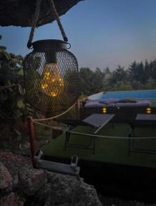 a light hanging from a building with a table and a boat at White House R&B in Campobello di Licata