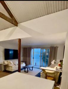 a living room with a bed and a view of the ocean at Overwater on the Murray in Murray Bridge