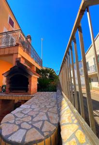 a bridge with a stone walkway next to a building at Casa Vacanze PIAZZETTA in San Nico